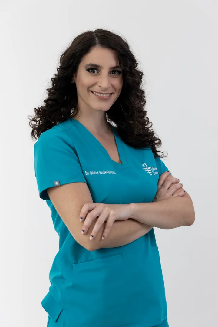 A licensed provider in teal scrubs, smiling, ready for a video visit